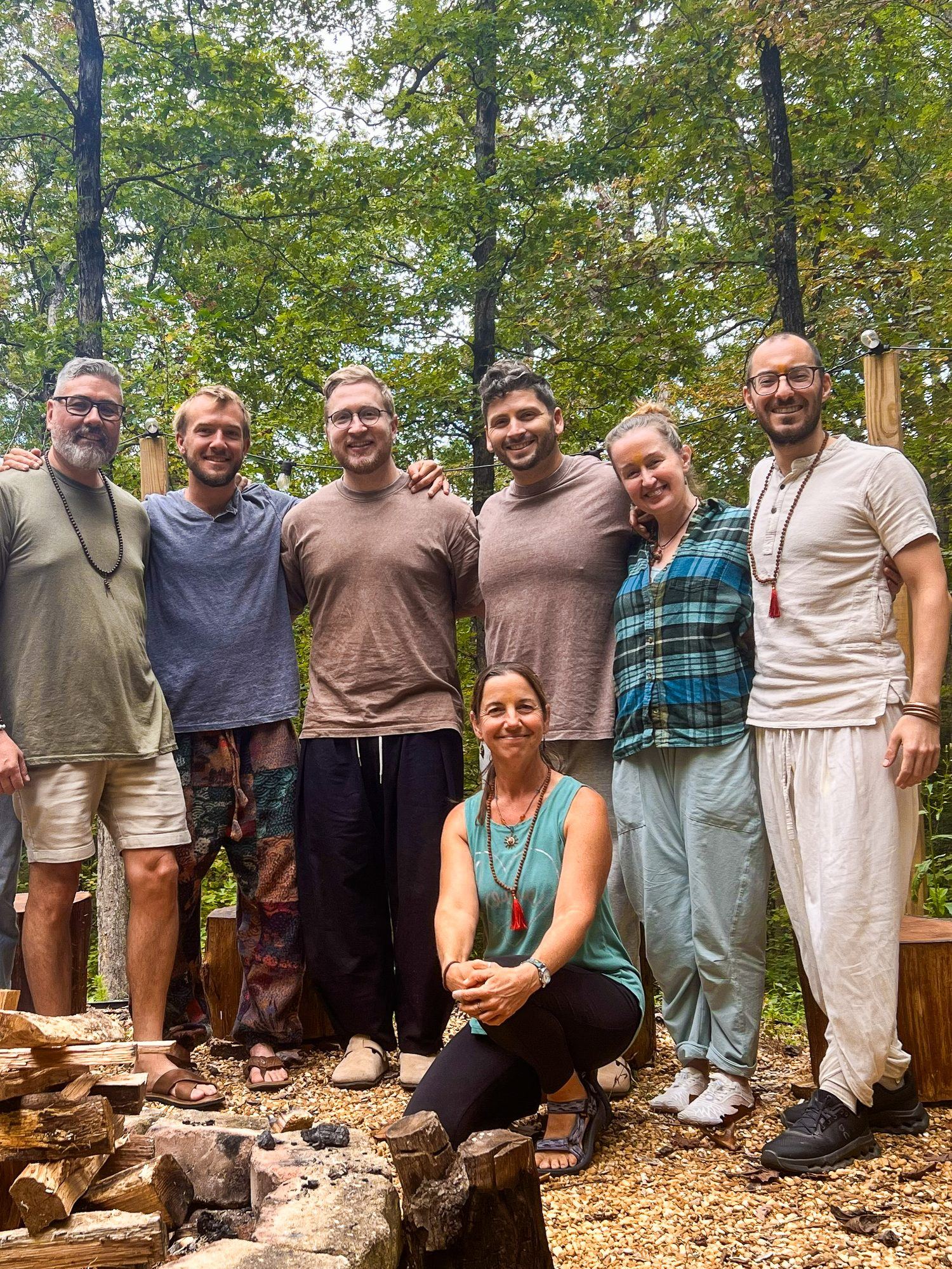 A retreat group gathered together outdoors in the forest