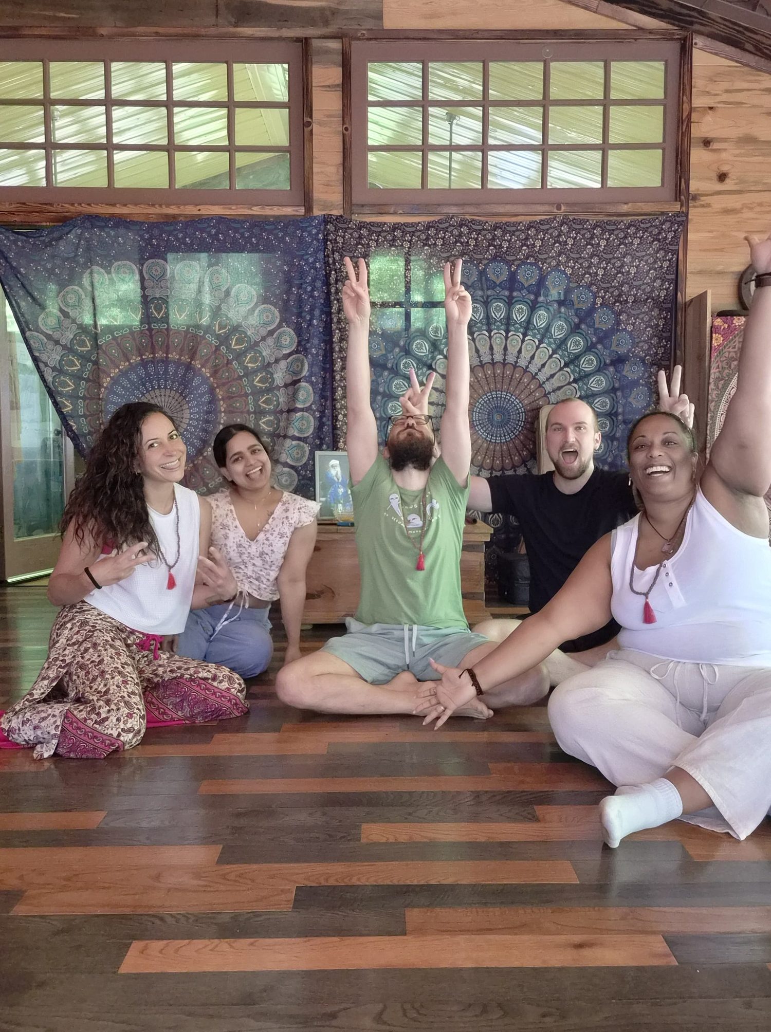 A joyful circle of practitioners throwing peace signs together