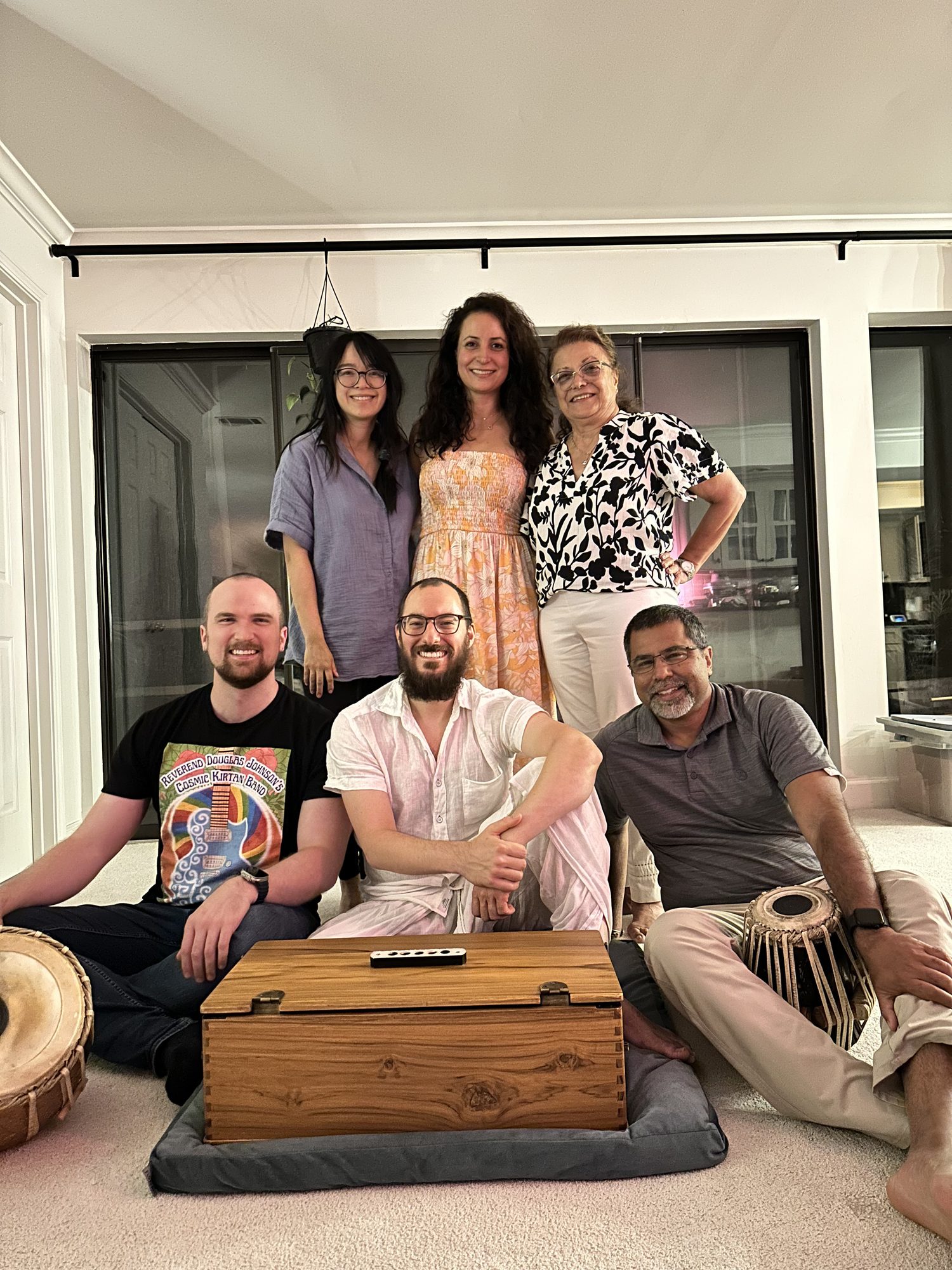 Community musicians gathered for a kirtan with harmonium and tabla